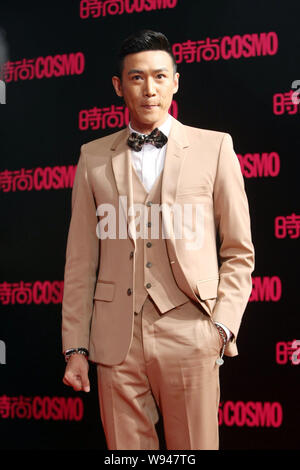 Chinese actor Lu Yi poses on the red carpet as he arrives at the 2013 Cosmo Grand Ceremony in Shanghai, China, 7 November 2013. Stock Photo