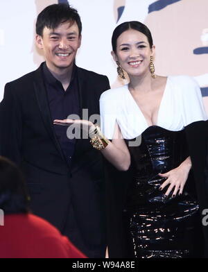 Taiwanese actor Zhang Zhen (left) and Chinese actress Zhang Ziyi pose as they arrive for the premiere of their latest movie, The Grandmaster, in Beiji Stock Photo