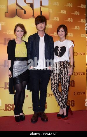 Gillian Chung, left, and Charlene Choi, right, of Hong Kong pop duo Twins pose with Hong Kong singer Ken Hung, center, as they arrive for a filming se Stock Photo