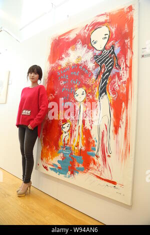 South Korean actress Ku Hye Sun poses with her painting at the opening event for her solo art exhibition, After Image, in Hong Kong, China, 14 October Stock Photo