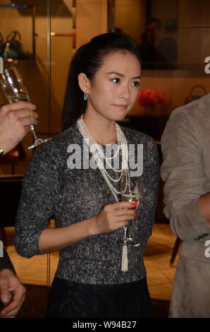 Chinese actress Zhang Ziyi is pictured holding champagne during the opening ceremony for a new Tods store at IAPM Mall in Shanghai, China, 16 November Stock Photo
