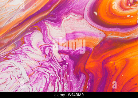 photography of abstract marbleized effect background. red, pink, orange and white creative colors. Beautiful paint Stock Photo