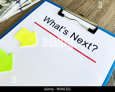 Clipboard with text what's next on wood desk. Stock Photo