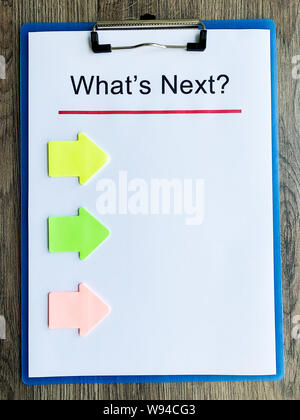 Clipboard with text what's next on wood desk. Stock Photo