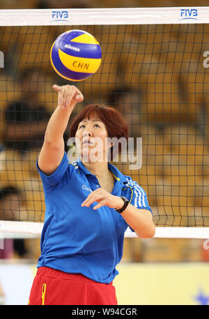 Head coach Jenny Lang Ping of China gives a shot during a training session to prepare for the World Grand Prix 2013 in Wuhan, central China Hubei prov Stock Photo