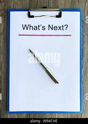 Clipboard with text what's next on wood desk. Stock Photo