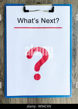 Clipboard with text what's next on wood desk. Stock Photo