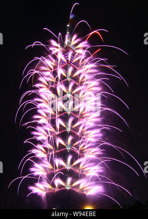Fireworks explode on the Taipei 101 during a New Year fireworks show before the midnight in Taipei, Taiwan, 31 December 2012. Stock Photo