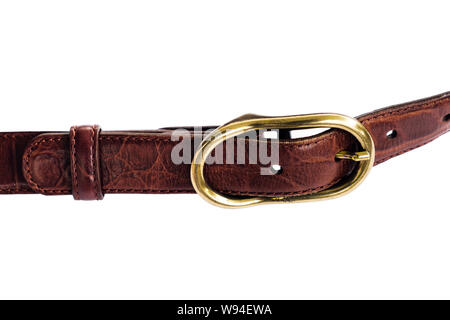 Close-up of a brass metal buckle on a stitched leather belt isolated on a white background. Stock Photo