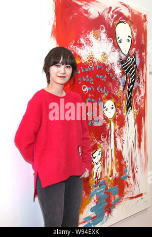 South Korean actress Ku Hye Sun poses with her painting at the opening event for her solo art exhibition, After Image, in Hong Kong, China, 14 October Stock Photo