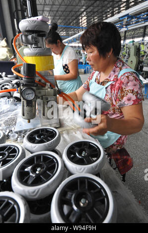 --FILE--Female Chinese workers assemble a car on the assembly line at ...