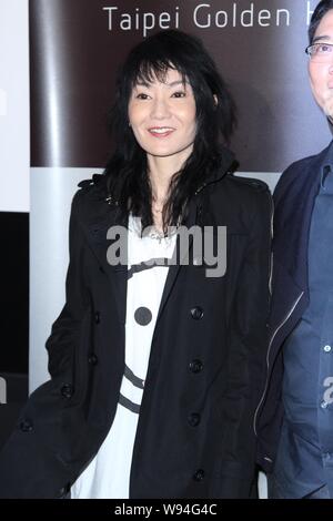 Hong Kong actress Maggie Cheung poses at a press conference for the 50th Taipei Golden Horse Film Festival in Taipei, Taiwan, 21 November 2013. Stock Photo