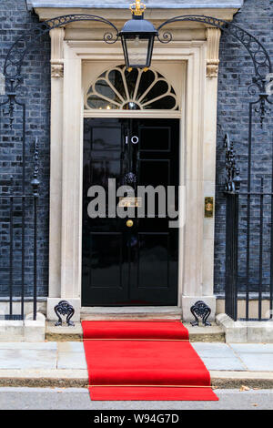 A red carpet is being installed and prepared outside No 10 Downing Street for a Head of State visit, London, UK Stock Photo