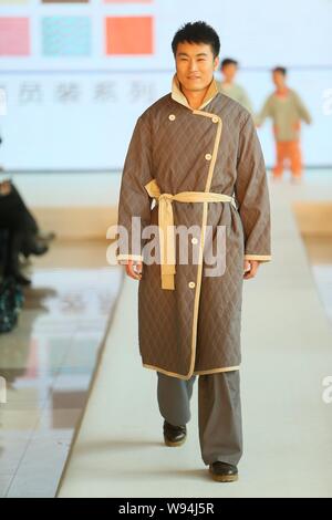 A Chinese doctor displays a new hospital uniform for patients during a fashion show in Beijing, China, 1 April 2013.   A special fashion show was held Stock Photo