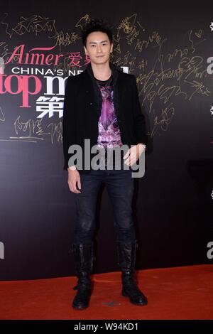 Taiwanese model and actor Joseph Cheng poses on the red carpet as he arrives at a fashion show of Chinese reality TV series, Chinas Next Top Model, in Stock Photo