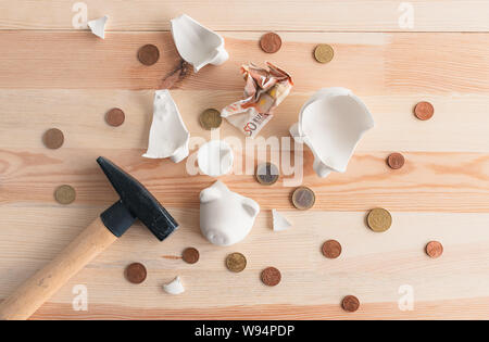 Euro coins and paper currency in broken piggy coin bank, money savings in home budget and finances concept Stock Photo