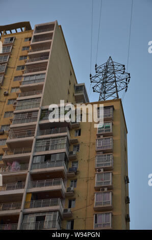 A pylon stands on the rooftop of a residential apartment building in Dazhou city, southwest Chinas Sichuan province, 17 April 2013.   A pylon mounted Stock Photo