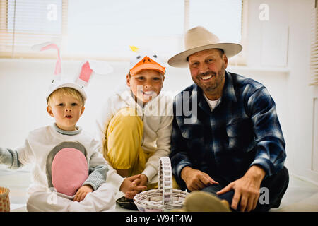 Father with his two sons dressed up for Easter Stock Photo