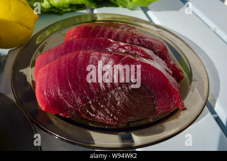 Big tuna steaks on the plate before cooking. Raw fresh tuna steaks Stock Photo