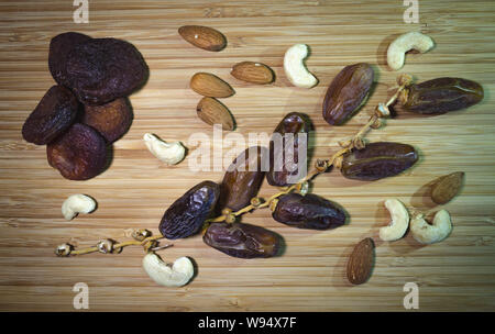 Dried healthy fruits and nuts - apricots, dates, almond and cashew Stock Photo
