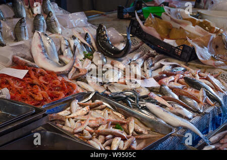 Fresh fish displayed at stall on local market of Catania, Sicily. Crates full of colored seafood in the fish market of Catania Stock Photo