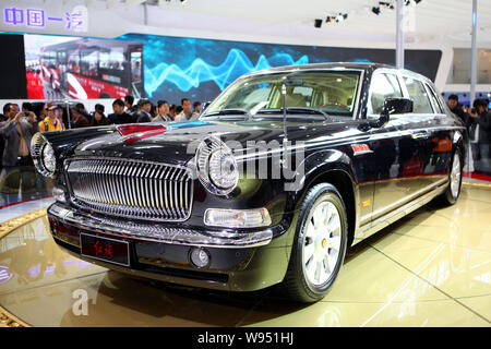 --FILE--Visitors look at a Red Flag (Hongqi) limousine of FAW during the 11th Beijing International Automotive Exhibition, known as Auto China 2010, i Stock Photo