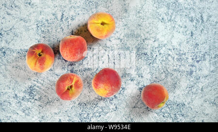 Whole apricots on blue marble like board, view from above Stock Photo