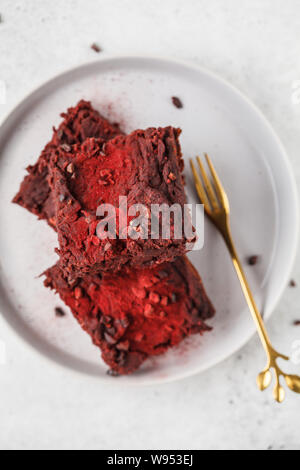 Beetroot vegan brownie on gray plate. Healthy vegan food concept. Stock Photo