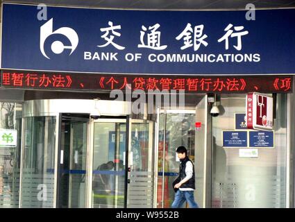 --File--A pedestrian walks past a branch of Bank of Communications (BoCom) in Shanghai, China, 9 April 2011.   Bank of Communications has got approval Stock Photo
