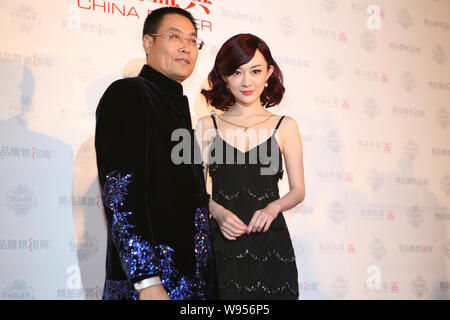 Chinese actress Huo Siyan poses next to a guest during a fashion awards ceremony in Beijing, China, 5 January 2012. Stock Photo