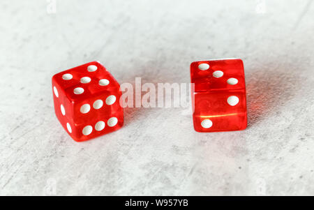 Two translucent red craps dices on white board showing Easy Eight number 5 and 3 Stock Photo