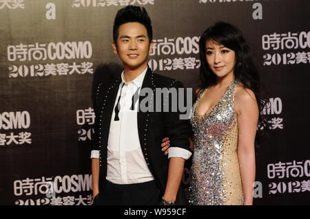 Chinese actress Emily Chen Zihan, right, Chinese director and actor Zhang Xiaolong pose on the red carpet as they arrive for the COSMO 2012 Beauty Awa Stock Photo