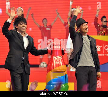 Chinese pianist Lang Lang, left, and Hong Kong singer Jacky Cheung, right, wave during a ceremony by Coca-Cola to release an Olympic theme song at the Stock Photo