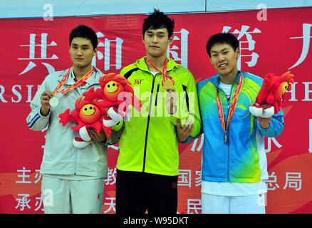 (From left) Silver medalist Li Yunqi, gold medalist and Olympic swimming champion Sun Yang, bronze medalist Li Yusen pose on the podium in the award c Stock Photo