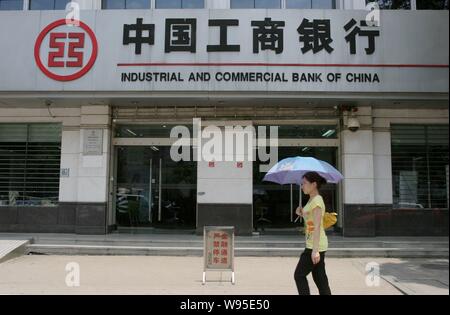 --File--A pedestrian walks past a branch of Industrial and Commercial Bank of China (ICBC) in Wuhan city, central Chinas Hubei province, 9 June 2012. Stock Photo