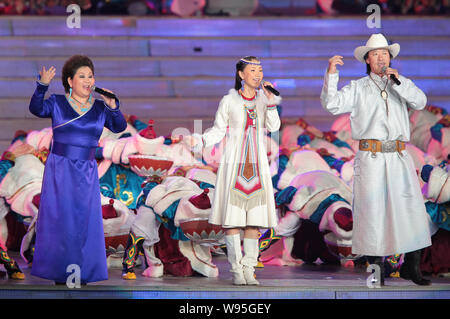 Members of Chinese Mongolian family music group Jixiang Sanbao perform at the opening ceremony of the 2nd Ordos International Nadam Fair in Ordos city Stock Photo