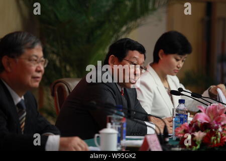 Chen Deming, center, Minister of Commerce of China, answers a question at a press conference during the 18th National Congress of the Communist Party Stock Photo