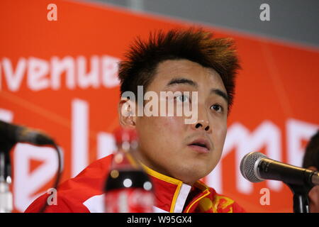 Silver medalist Wang Hao of China speaks at a press conference after being defeated by his compatriot Zhang Jike in the final of the mens singles tabl Stock Photo