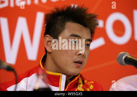 Silver medalist Wang Hao of China speaks at a press conference after being defeated by his compatriot Zhang Jike in the final of the mens singles tabl Stock Photo
