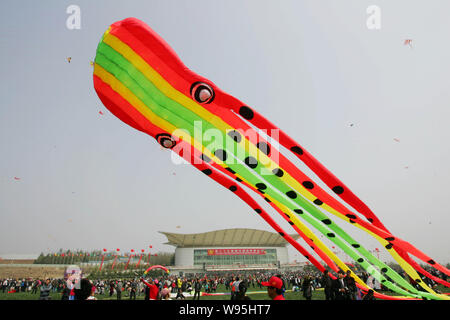 People fly kites during the 29th Weifang International Kite Festival in Weifang city, east Chinas Shandong province, 22 April 2012.   The 29th Weifang Stock Photo