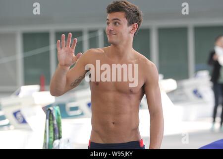 Olympic diving bronze medalist Thomas Daley of Britain waves during a training and demonstration session to coach young Chinese and British diving fan Stock Photo