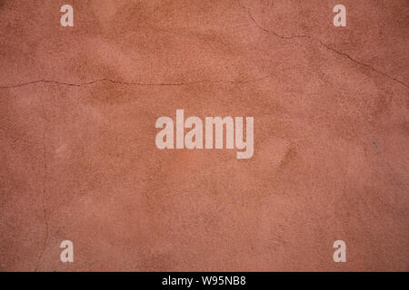 Wall plastered and painted background texture. Exterior building wall facade brown red color blank empty, copy space Stock Photo