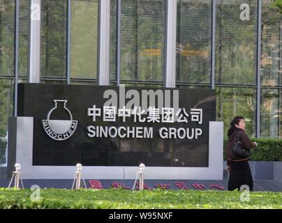 --File--A pedestrian walks past the headquarters of Sinochem Group in Beijing, China, 8 July 2011.   Sinochem Group, Chinas fourth-biggest oil produce Stock Photo