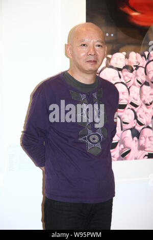 Chinese contemporary artist Yue Minjun poses during the opening ceremony of his art exhibition, The Tao of Laughter, in Hong Kong, China, 24 September Stock Photo