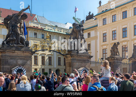Crowd of tourists and audiences wait to see the march or parade of soldiers in front of Matthias Gate, entrance of courtyard of Prague Castle. Stock Photo