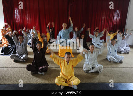 Chinese Buddist monks and nuns of Guangxuan Art Troupe perform a Zen dance during a training session at Tiantai Temple on Tiantai Mountain in HongAn c Stock Photo