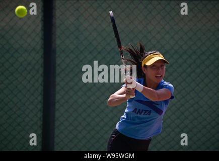 Chinese tennis player Zheng Jie returns a shot during a training session for Fed Cup in Shenzhen, south Chinas Guangdong province, 31 January 2012. Stock Photo