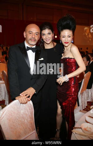 Famous shoe designer Chistian Louboutin (L) and former Olympic swimming champion Zhuang Yong (M) pose at the Shanghai Soong Ching Ling Foundation Miss Stock Photo
