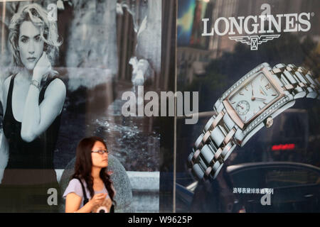 FILE A woman walks past an advertisement for Longines watches in