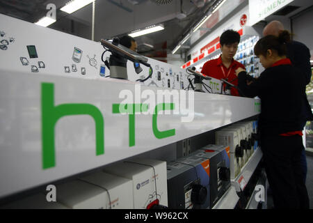 --File--Shoppers try out HTC smartphones at a Media Markt store in Shanghai, China, 17 November 2010.   Packed with a number of popular Chinese apps, Stock Photo